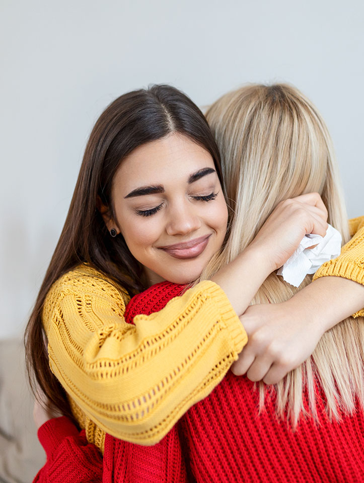 Two young women embracing