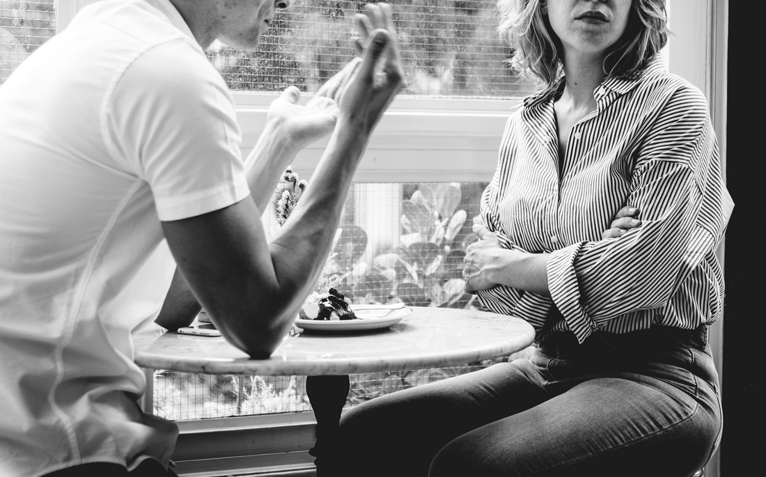 An unhappy man and woman involved in verbal confrontation